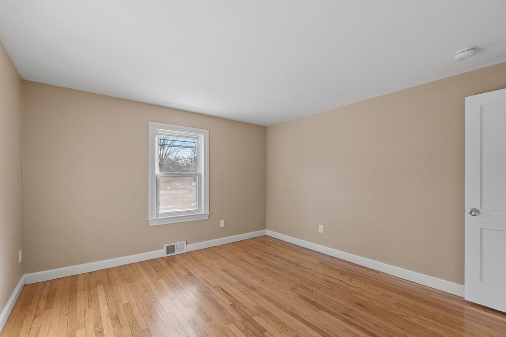 22 Parker Road Shirley, MA 01464 - Photo 13 of 41 an empty room with wooden floor and windows