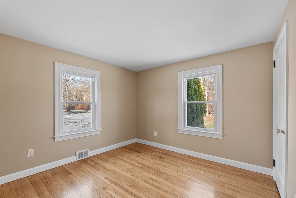 22 Parker Road Shirley, MA 01464 - Photo 14 of 41 a view of an empty room with window and wooden floor