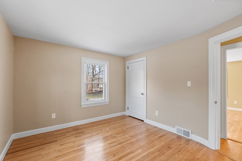 22 Parker Road Shirley, MA 01464 - Photo 15 of 41 a view of an empty room with wooden floor and a window