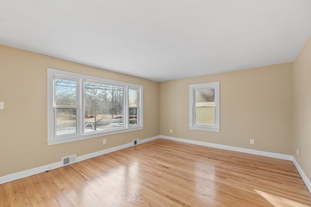 22 Parker Road Shirley, MA 01464 - Photo 17 of 41 a view of an empty room with wooden floor and a window