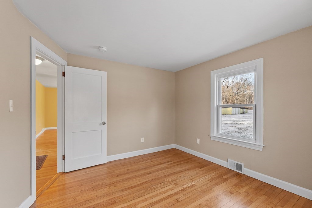 22 Parker Road Shirley, MA 01464 - Photo 18 of 41 a view of an empty room with wooden floor and a window