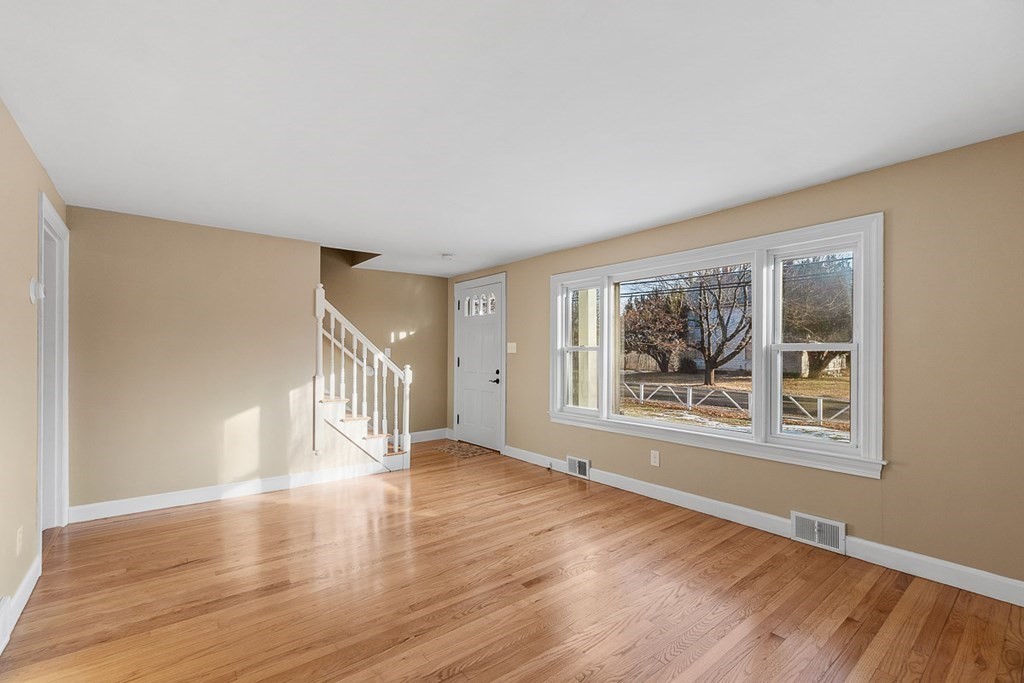 22 Parker Road Shirley, MA 01464 - Photo 20 of 41 a view of an empty room with wooden floor and a window