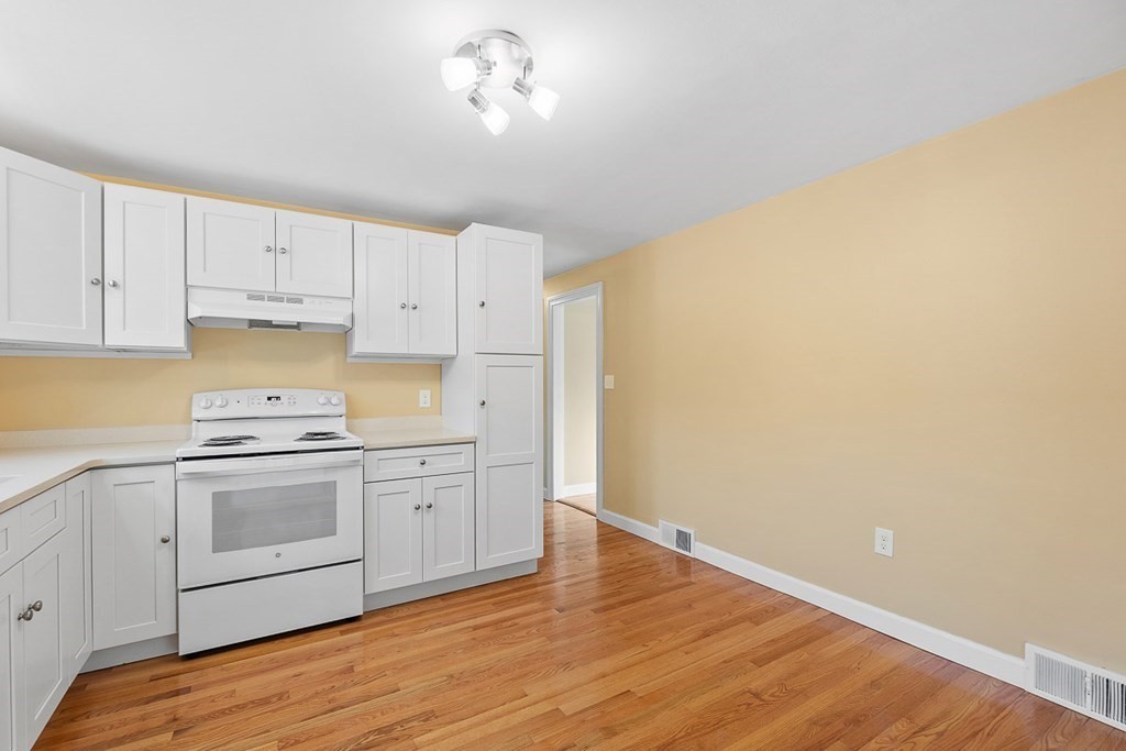 22 Parker Road Shirley, MA 01464 - Photo 4 of 41 a kitchen with granite countertop white cabinets and white appliances