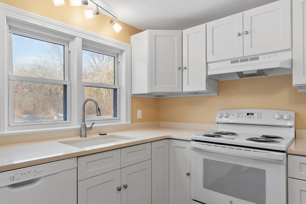 22 Parker Road Shirley, MA 01464 - Photo 6 of 41 a kitchen with white cabinets appliances and a sink