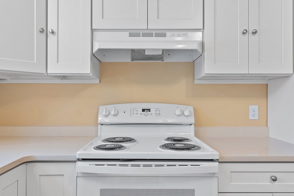 22 Parker Road Shirley, MA 01464 - Photo 7 of 41 a kitchen with a stove and white cabinets