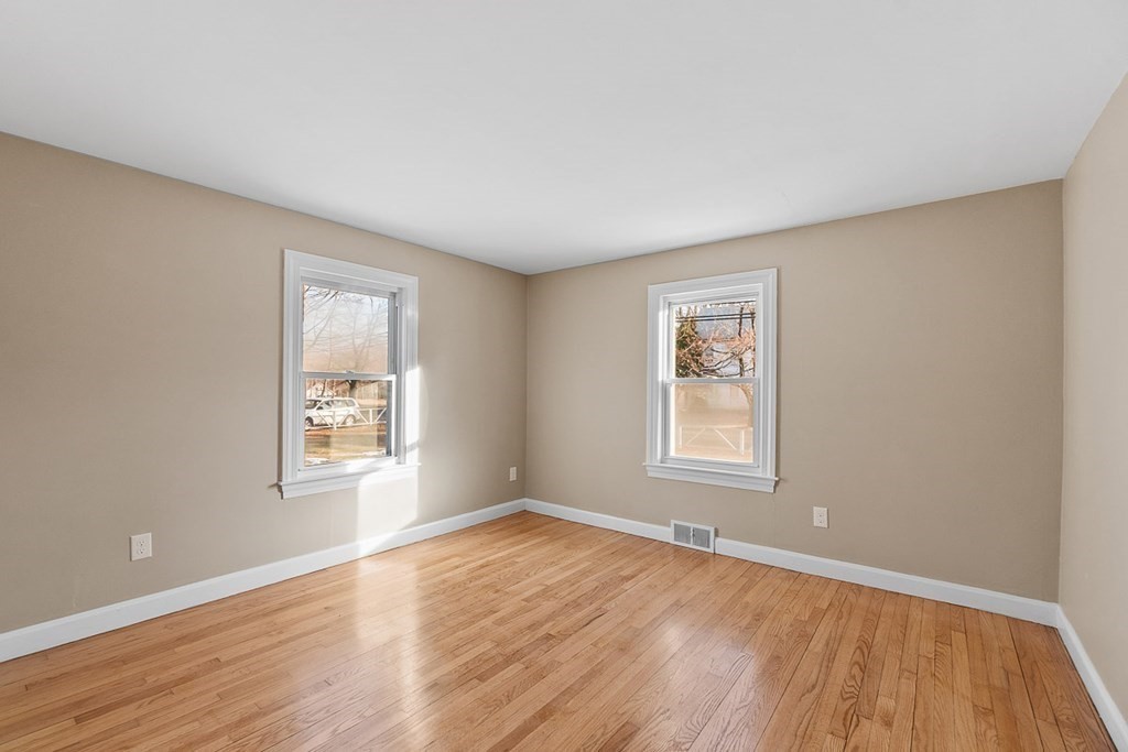 22 Parker Road Shirley, MA 01464 - Photo 10 of 41 an empty room with wooden floor and windows