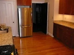 a view of a kitchen with a refrigerator and a stove