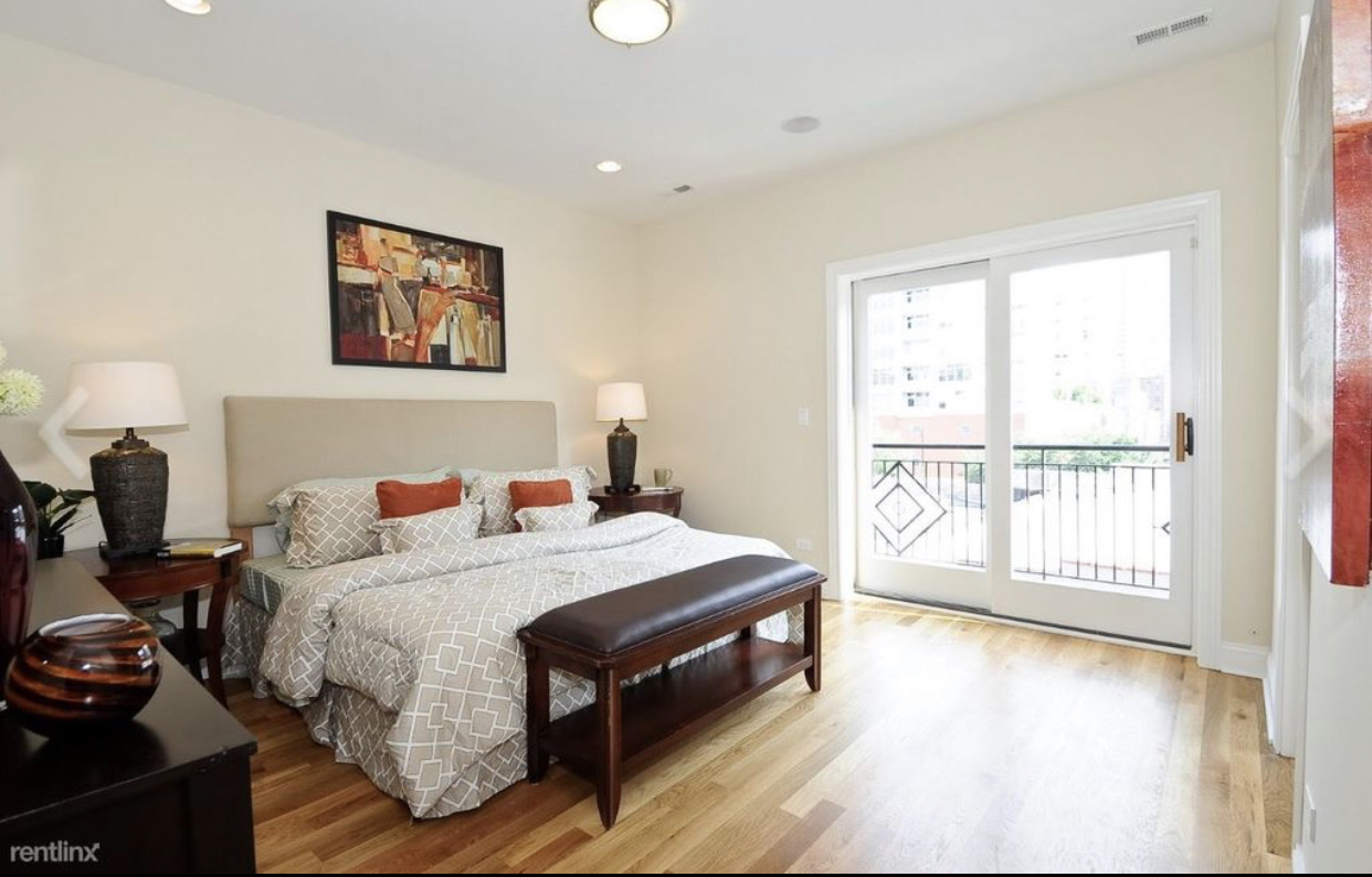 27 North Morgan Street, Unit 3 Chicago, IL 60607 - Photo 3 of 6 a bedroom with a bed and wooden floor