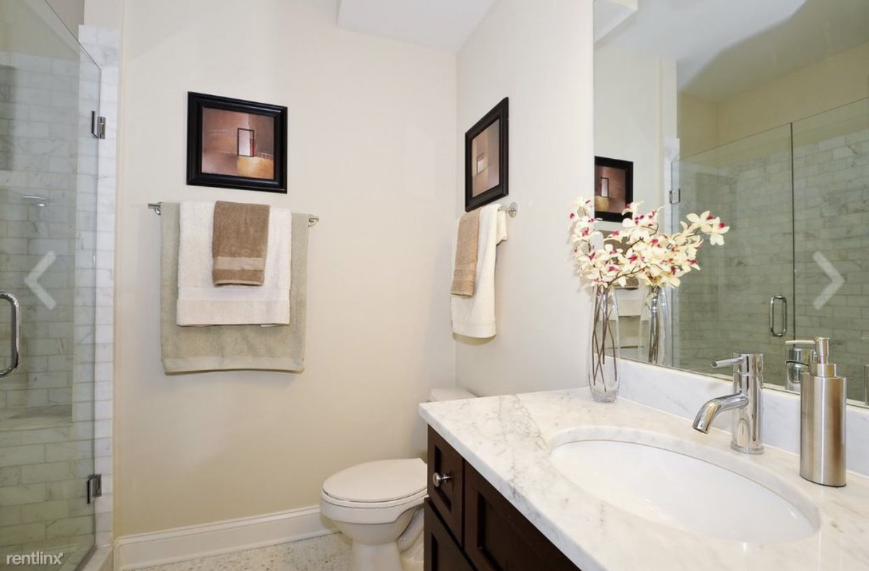 27 North Morgan Street, Unit 3 Chicago, IL 60607 - Photo 4 of 6 a bathroom with a granite countertop sink mirror vanity and toilet