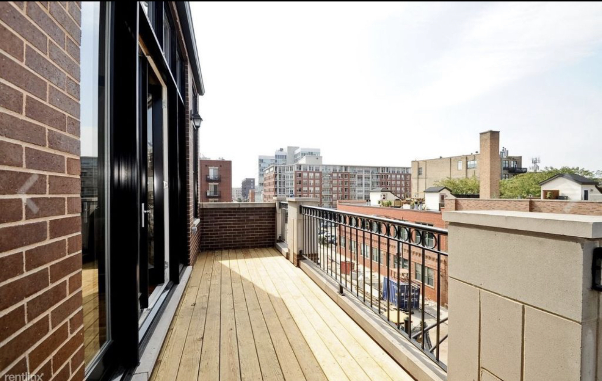 27 North Morgan Street, Unit 3 Chicago, IL 60607 - Photo 5 of 6 a view of balcony with a floor to ceiling window and wooden floor
