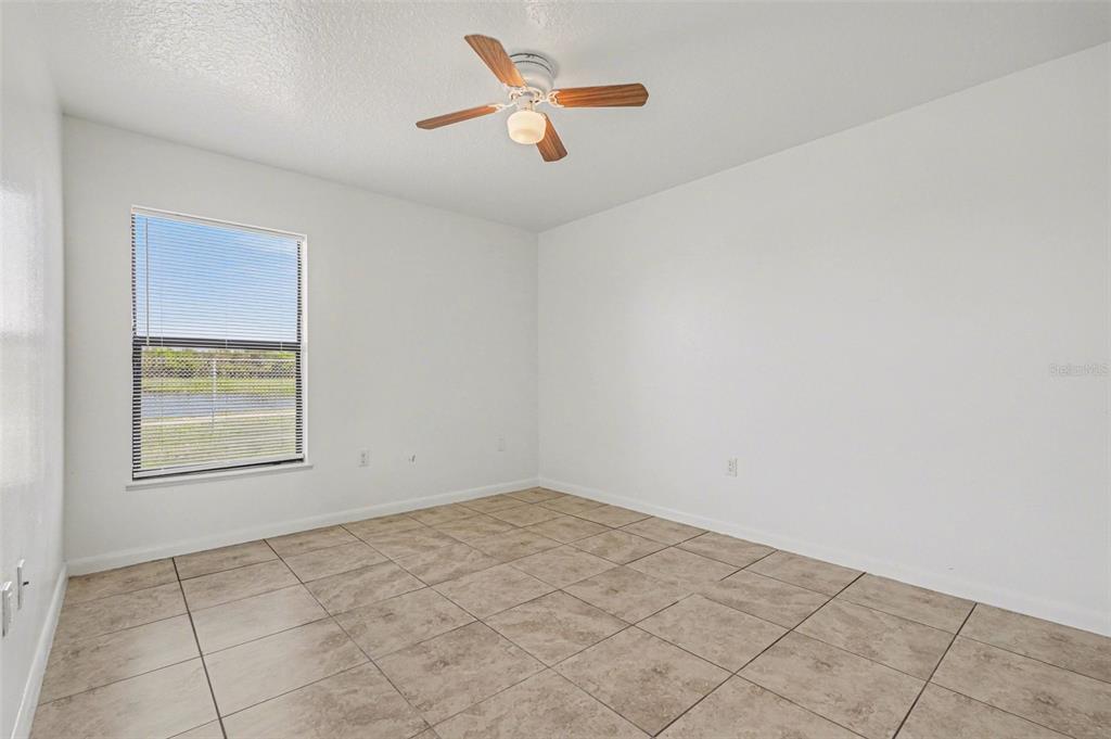 816 Angela Avenue, Unit B Rockledge, FL 32955 - Photo 11 of 34 an empty room with a window and a ceiling fan