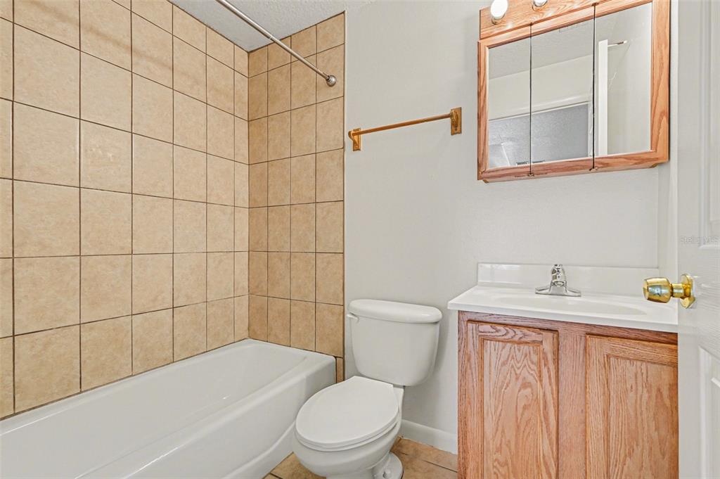 816 Angela Avenue, Unit B Rockledge, FL 32955 - Photo 12 of 34 a bathroom with a sink a toilet and shower