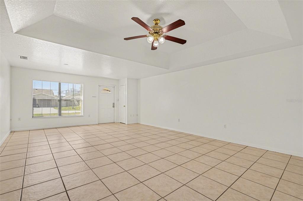 816 Angela Avenue, Unit B Rockledge, FL 32955 - Photo 3 of 34 an empty room with windows and ceiling fan