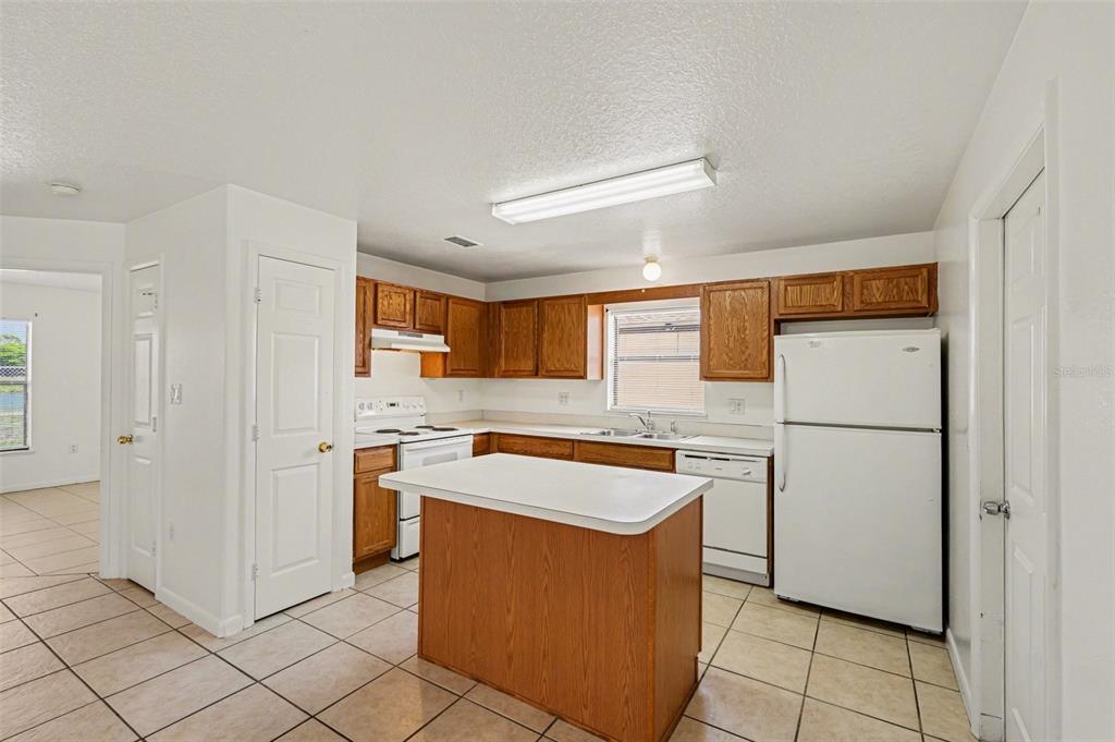 816 Angela Avenue, Unit B Rockledge, FL 32955 - Photo 4 of 34 a kitchen with stainless steel appliances granite countertop a refrigerator sink and cabinets
