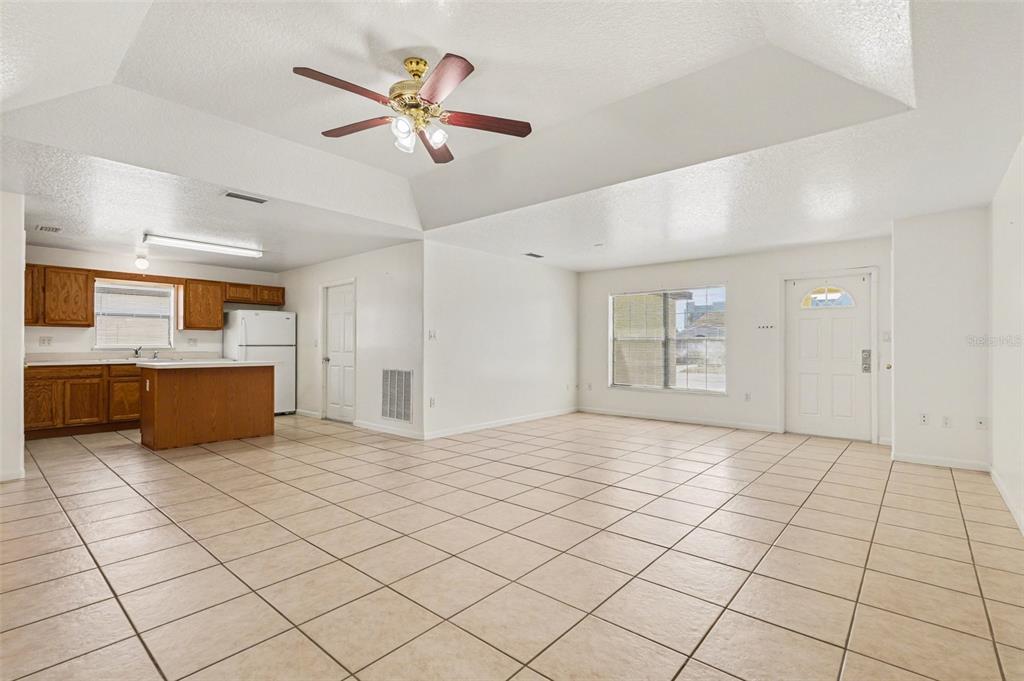 816 Angela Avenue, Unit B Rockledge, FL 32955 - Photo 5 of 34 a view of a kitchen with a sink dishwasher and a refrigerator with wooden floor