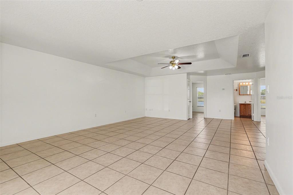 816 Angela Avenue, Unit B Rockledge, FL 32955 - Photo 6 of 34 a view of an empty room and a chandelier fan
