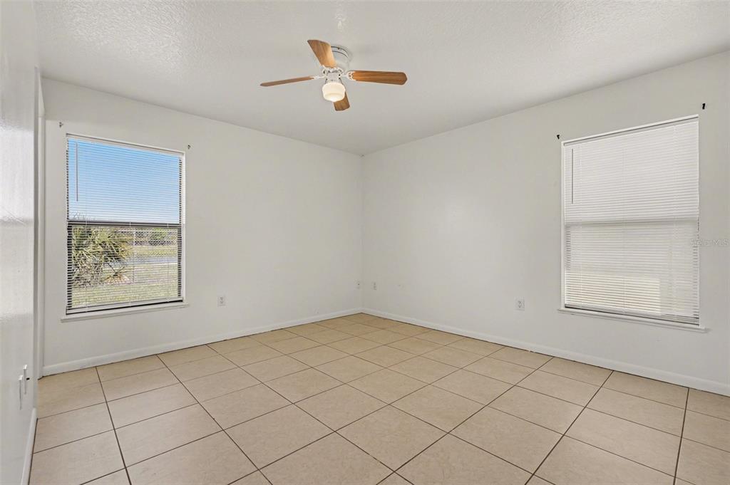 816 Angela Avenue, Unit B Rockledge, FL 32955 - Photo 7 of 34 an empty room with windows and ceiling fan