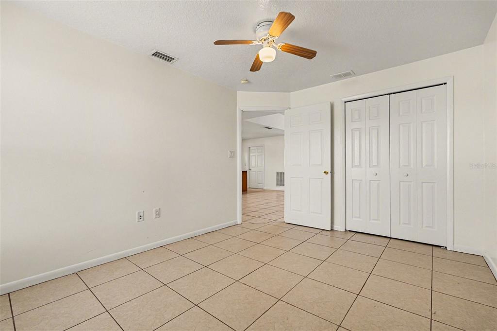 816 Angela Avenue, Unit B Rockledge, FL 32955 - Photo 10 of 34 a view of a closet and chandelier fan in a room
