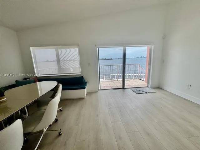 a view of a room with furniture and wooden floor