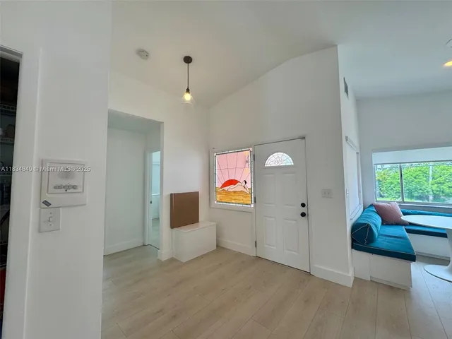 an empty room with windows and cabinet