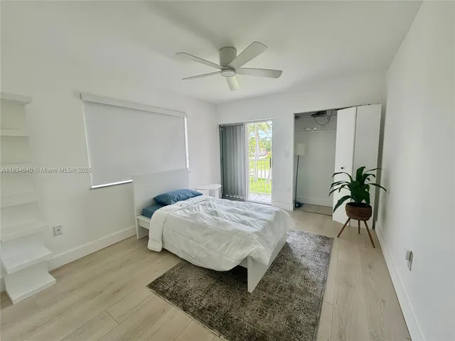 a bedroom with a bed and a potted plant