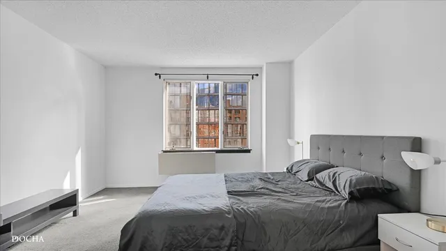 a bedroom with a bed and window