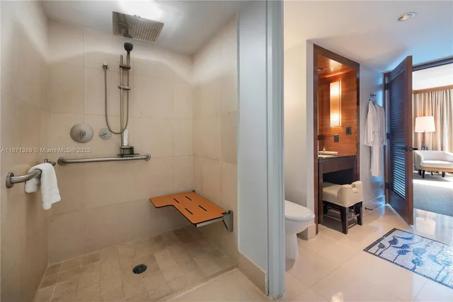 a view of a hallway with glass door and chandelier