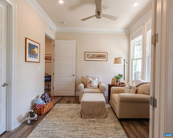 a work room with furniture potted plant and a window