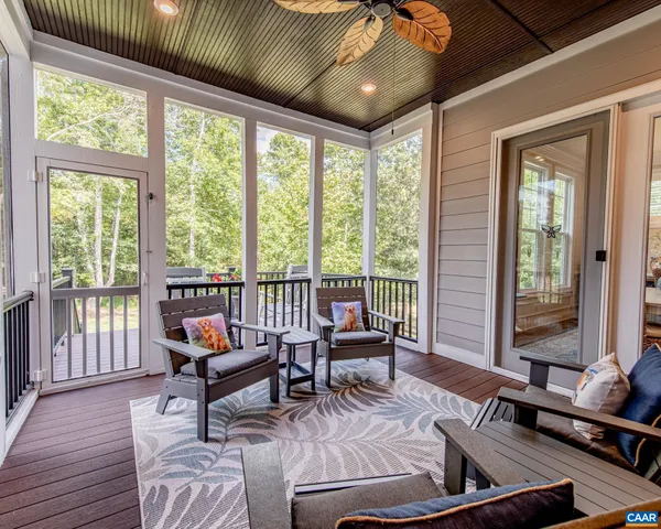 a balcony view with a large window and sitting space