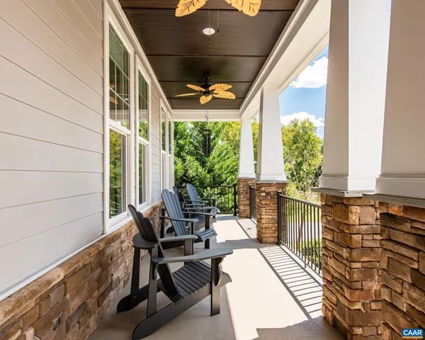 a spacious bathroom with a granite countertop double vanity sink a mirror and a