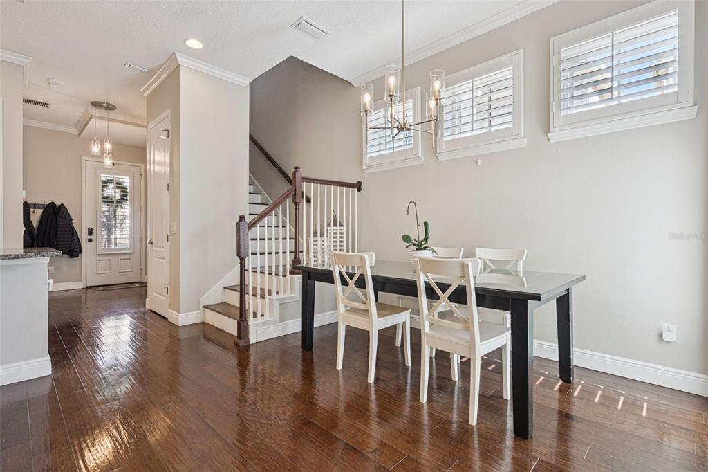 1565 Castile Street Celebration, FL 34747 - Photo 13 of 82 a view of a dining room with furniture wooden floor and chandelier