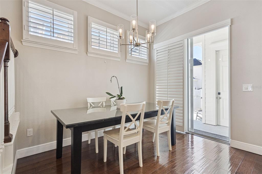 1565 Castile Street Celebration, FL 34747 - Photo 14 of 82 a view of a dining room with furniture wooden floor and chandelier
