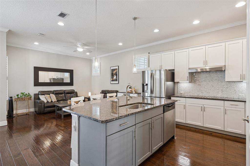 1565 Castile Street Celebration, FL 34747 - Photo 20 of 82 a kitchen with stainless steel appliances granite countertop a sink stove and cabinets
