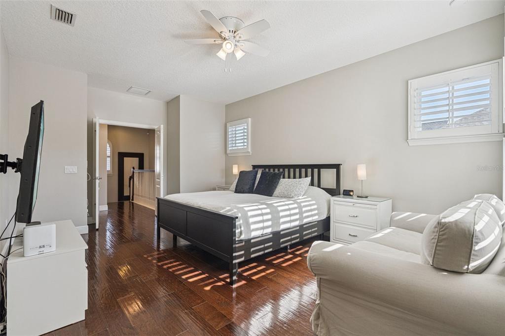 1565 Castile Street Celebration, FL 34747 - Photo 31 of 82 a bedroom with two beds and a chandelier