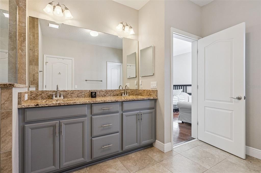 1565 Castile Street Celebration, FL 34747 - Photo 32 of 82 a bathroom with a granite countertop sink and a mirror