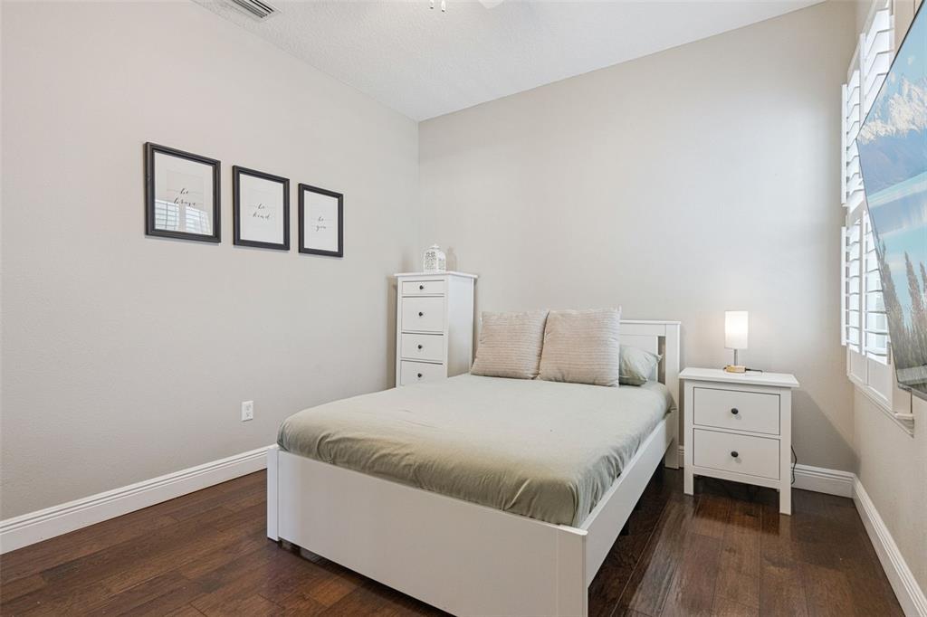 1565 Castile Street Celebration, FL 34747 - Photo 37 of 82 a bedroom with a bed and a window