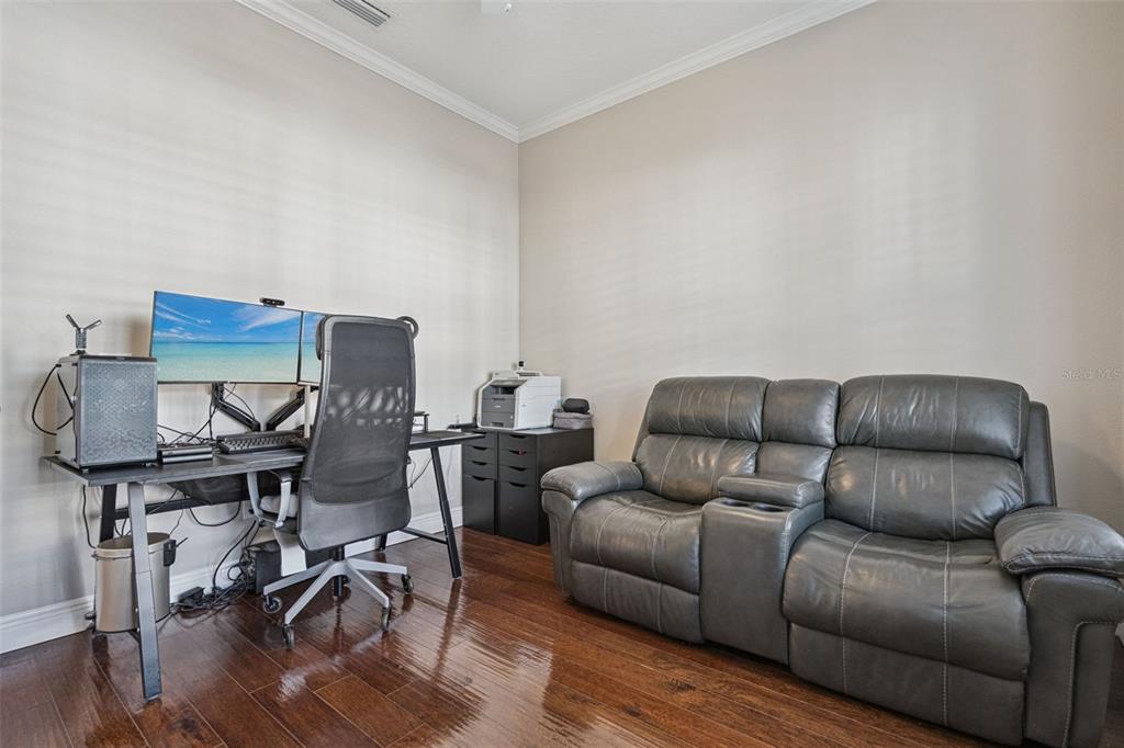 1565 Castile Street Celebration, FL 34747 - Photo 10 of 82 a living room with furniture and a wooden floor
