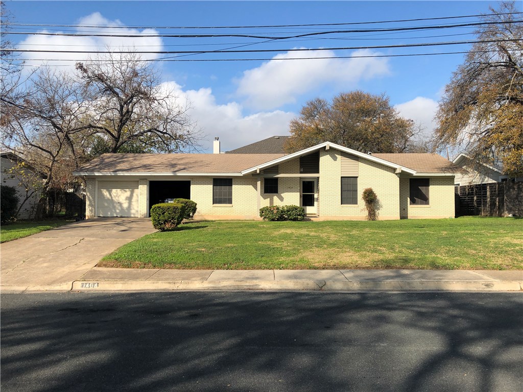 a view of a yard in front view of a house