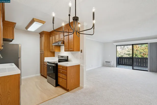 a kitchen with stainless steel appliances granite countertop a sink a stove and a refrigerator