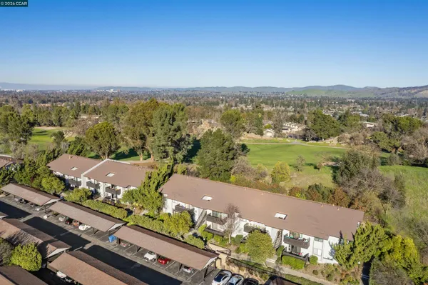 an aerial view of residential building and lake