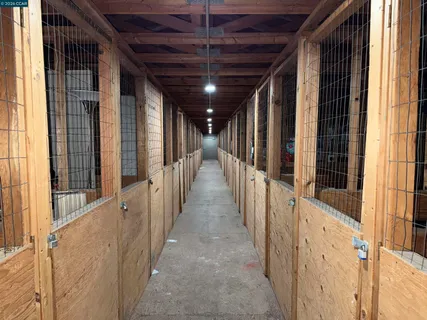a view of house with swimming pool and sitting area