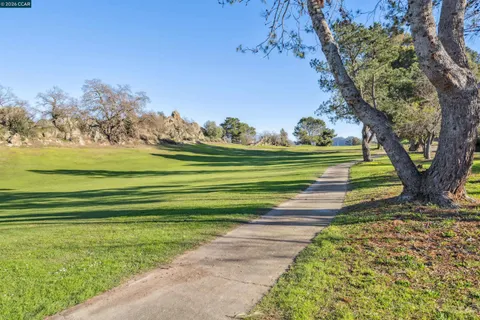 an aerial view of a house with a mountain