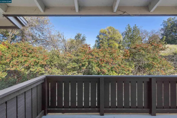 a balcony with wooden floor and fence