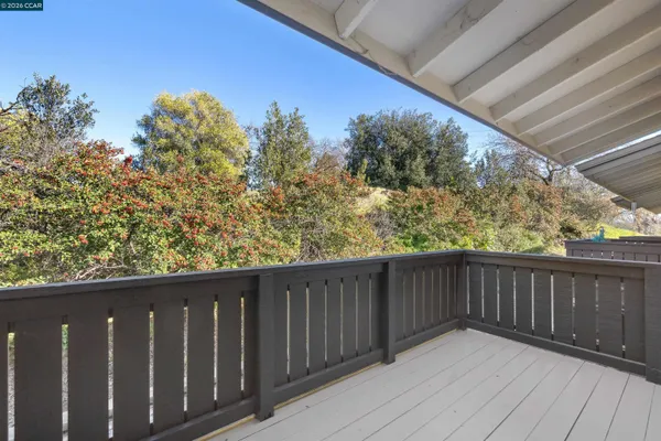 a view of a balcony with wooden floor