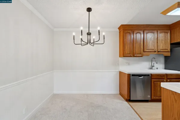a kitchen with stainless steel appliances granite countertop a sink a stove and a refrigerator