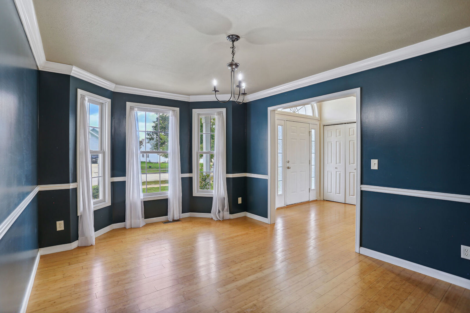905 Switchgrass Lane Champaign, IL 61822 - Photo 11 of 51 a view of a livingroom with wooden floor and windows