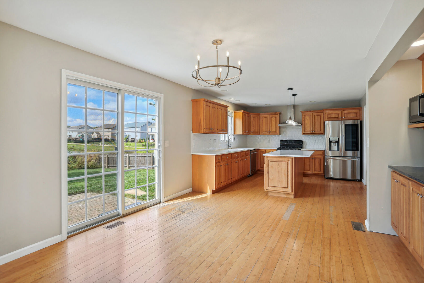 905 Switchgrass Lane Champaign, IL 61822 - Photo 13 of 51 a view of kitchen with wooden floor and electronic appliances