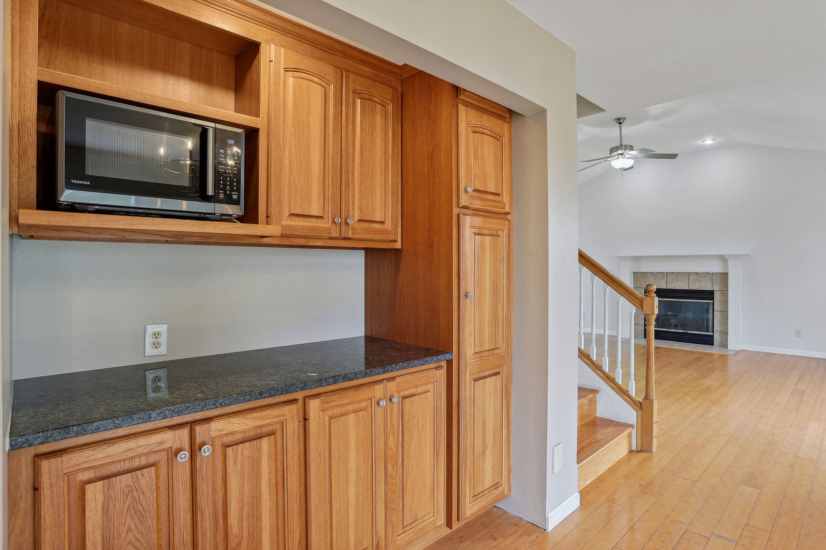 905 Switchgrass Lane Champaign, IL 61822 - Photo 15 of 51 a kitchen with stainless steel appliances granite countertop a refrigerator a stove and a sink with wooden floor