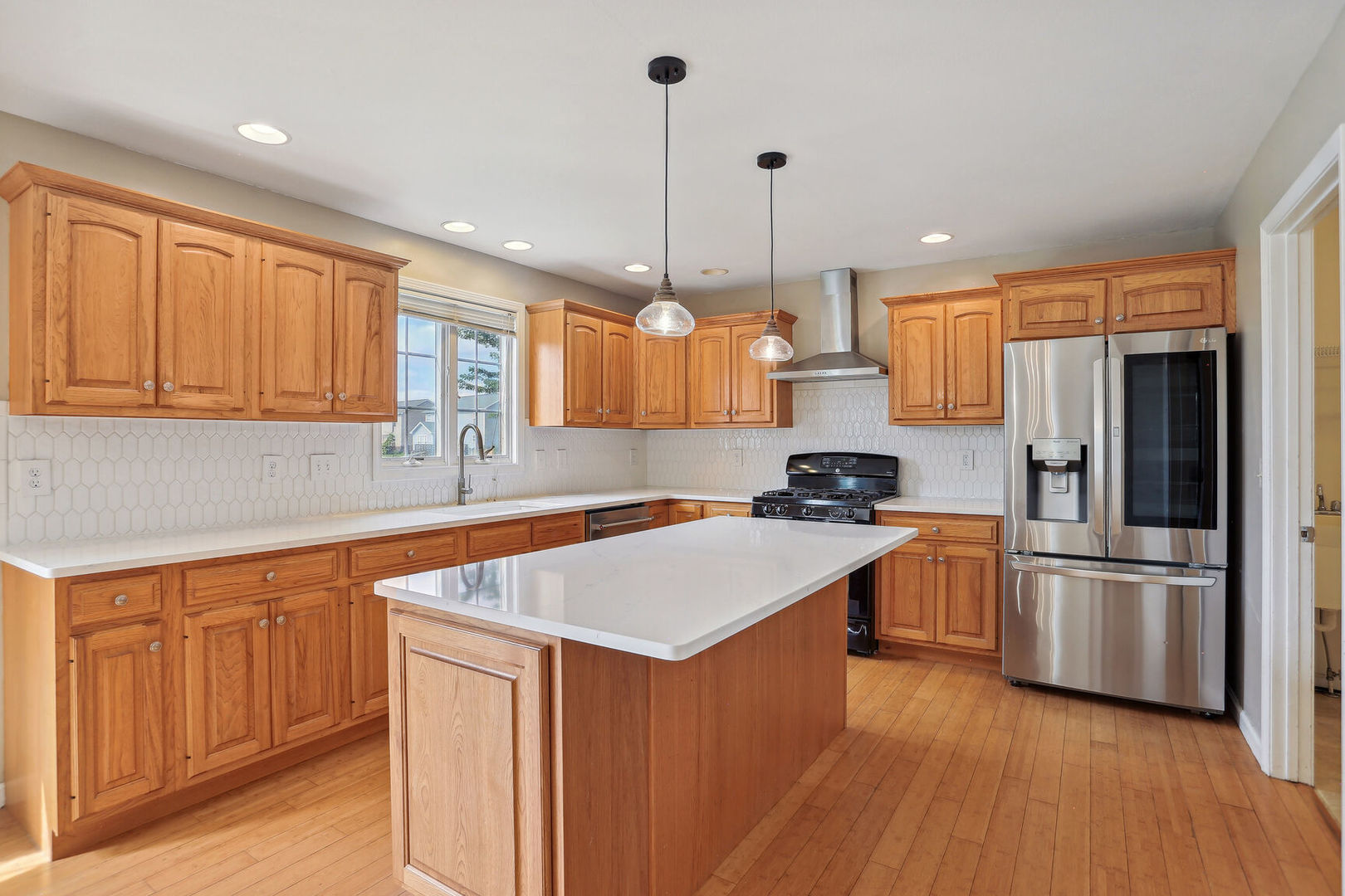 905 Switchgrass Lane Champaign, IL 61822 - Photo 16 of 51 a kitchen with stainless steel appliances granite countertop a sink stove and refrigerator