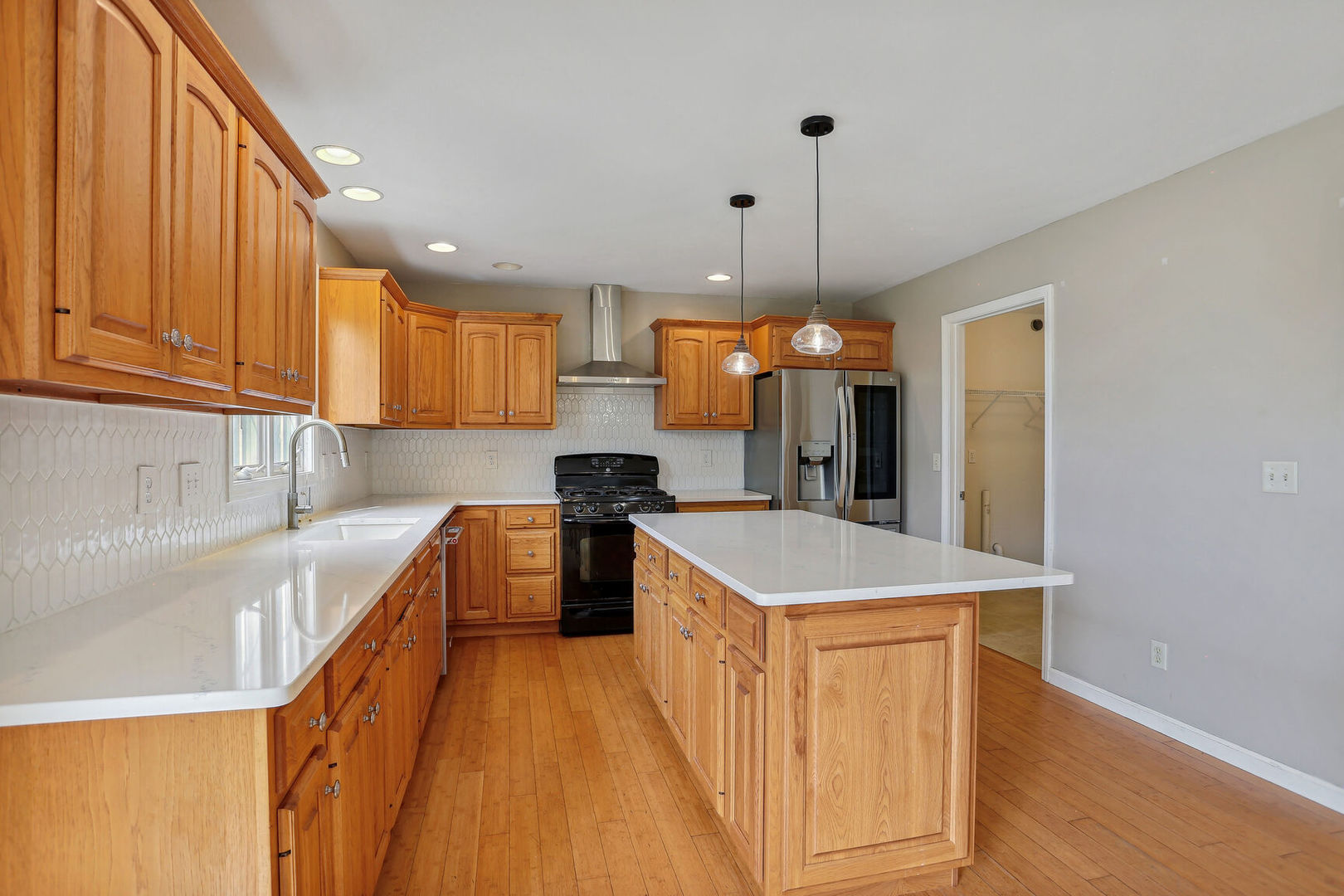 905 Switchgrass Lane Champaign, IL 61822 - Photo 17 of 51 a kitchen with a sink a counter top space stainless steel appliances and cabinets